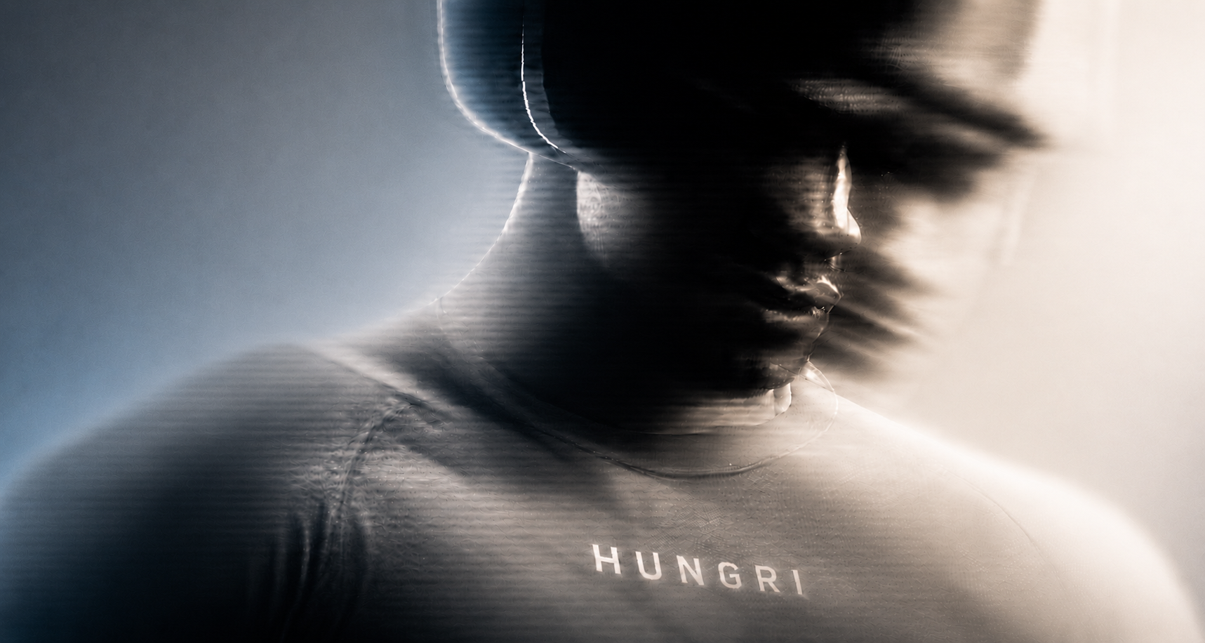 HUNGRI premium gymwear hero — model in heavyweight hoodie, built for the relentless